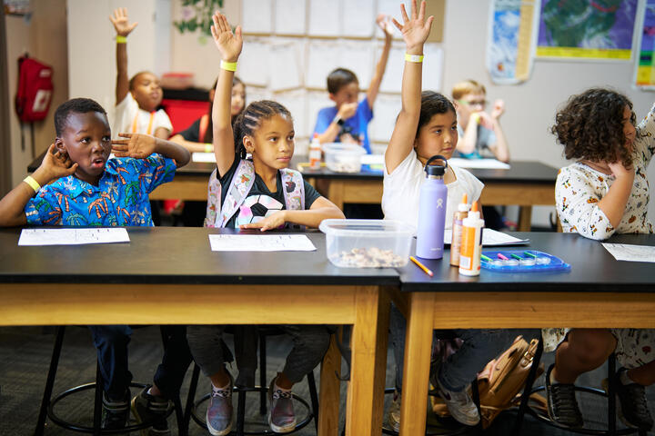 Photo of children raising their hands